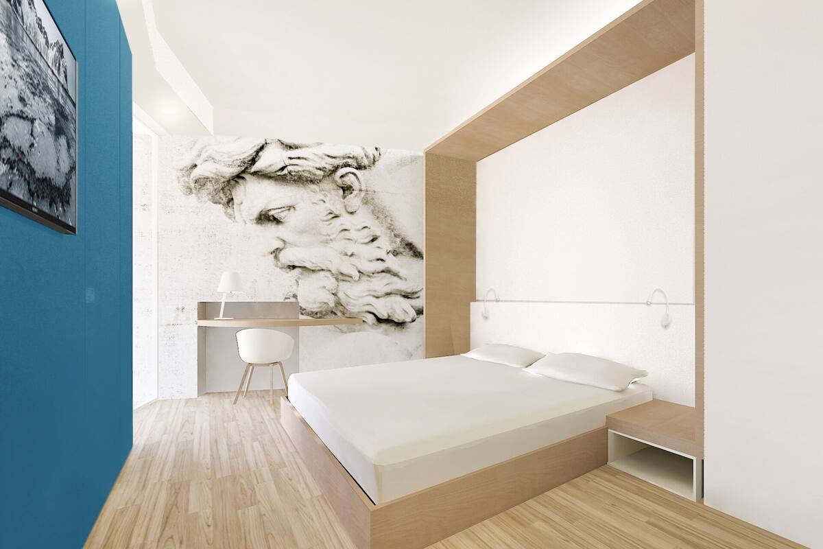 A modern bedroom with a large bed, a built-in desk, and a unique marble mural on the wall.