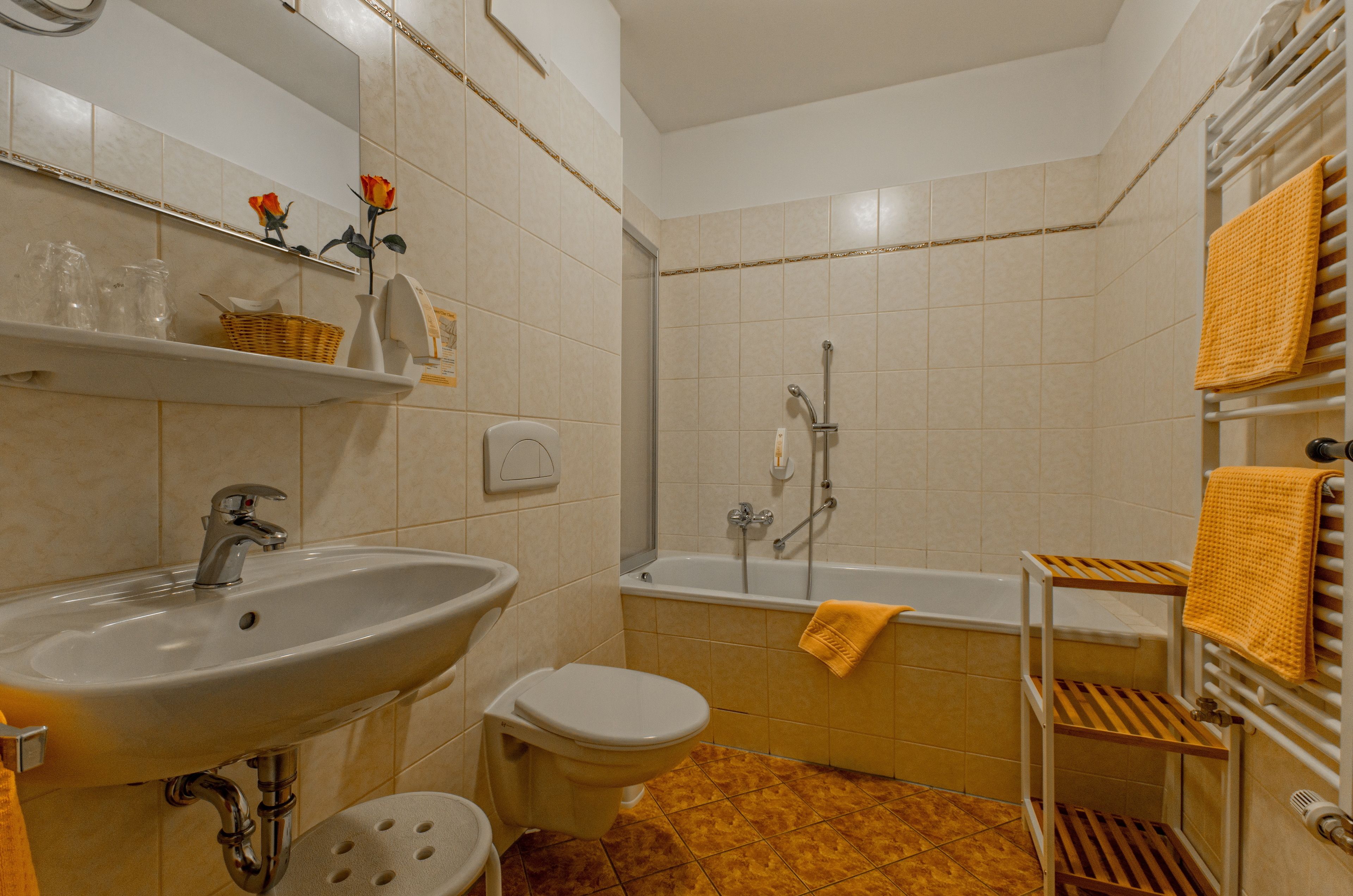 Un baño con lavamanos, inodoro y bañera.