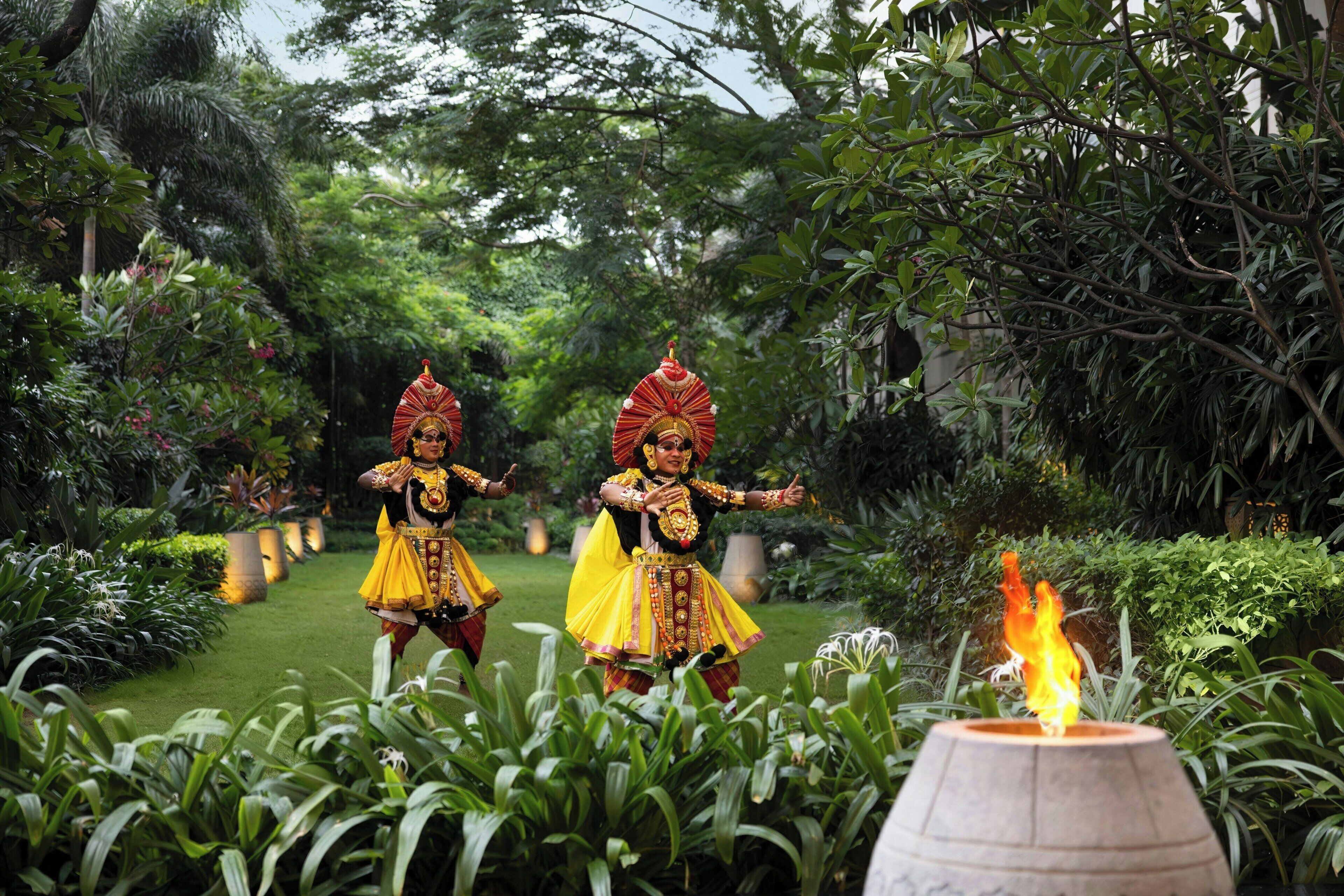 A garden with a fire feature and lush greenery.