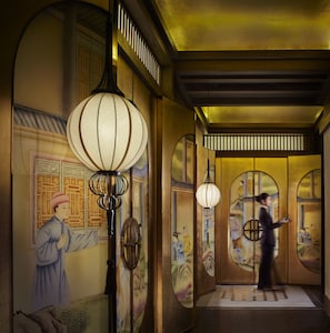 A traditional interior with a person walking, ornate wall decorations, and hanging lamps. - The Ritz-Carlton, Chengdu (Chengdu)