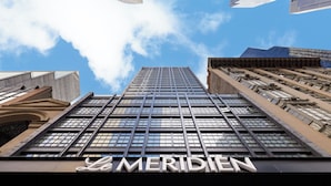 A high-rise building with the name "Le Meridien" prominently displayed at the bottom. - Le Meridien New York, Central Park by Marriott (New York)