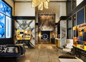 Sitting area in hotel lobby at Le Meridien New York, Central Park by Marriott