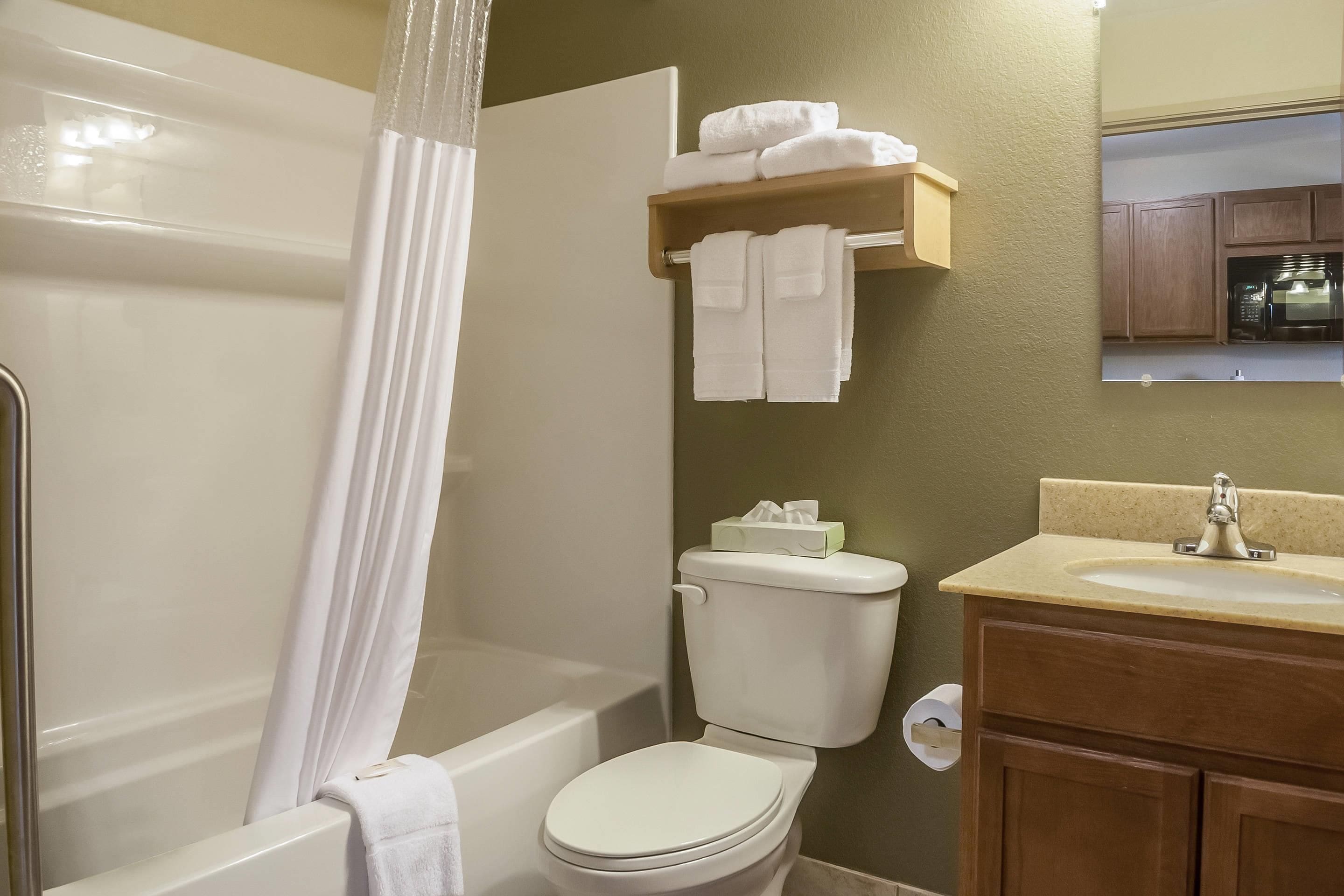 A bathroom with a bathtub, toilet, and sink.