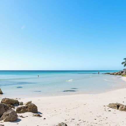 On the beach, white sand, sun loungers, beach towels