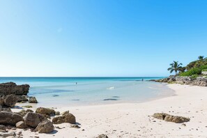 On the beach, white sand, sun loungers, beach towels