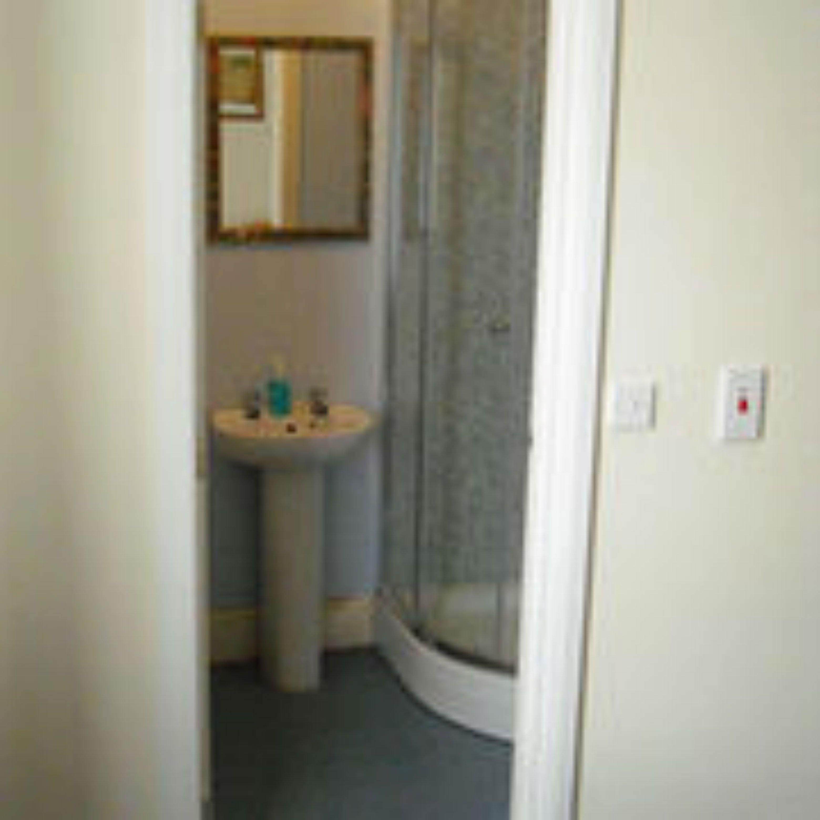 Ein Badezimmer mit Waschbecken, Spiegel und Dusche.