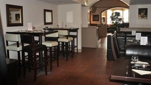 A restaurant with a bar area, dining tables, and booths. - The Locomotion Hotel (Stockton-on-Tees)