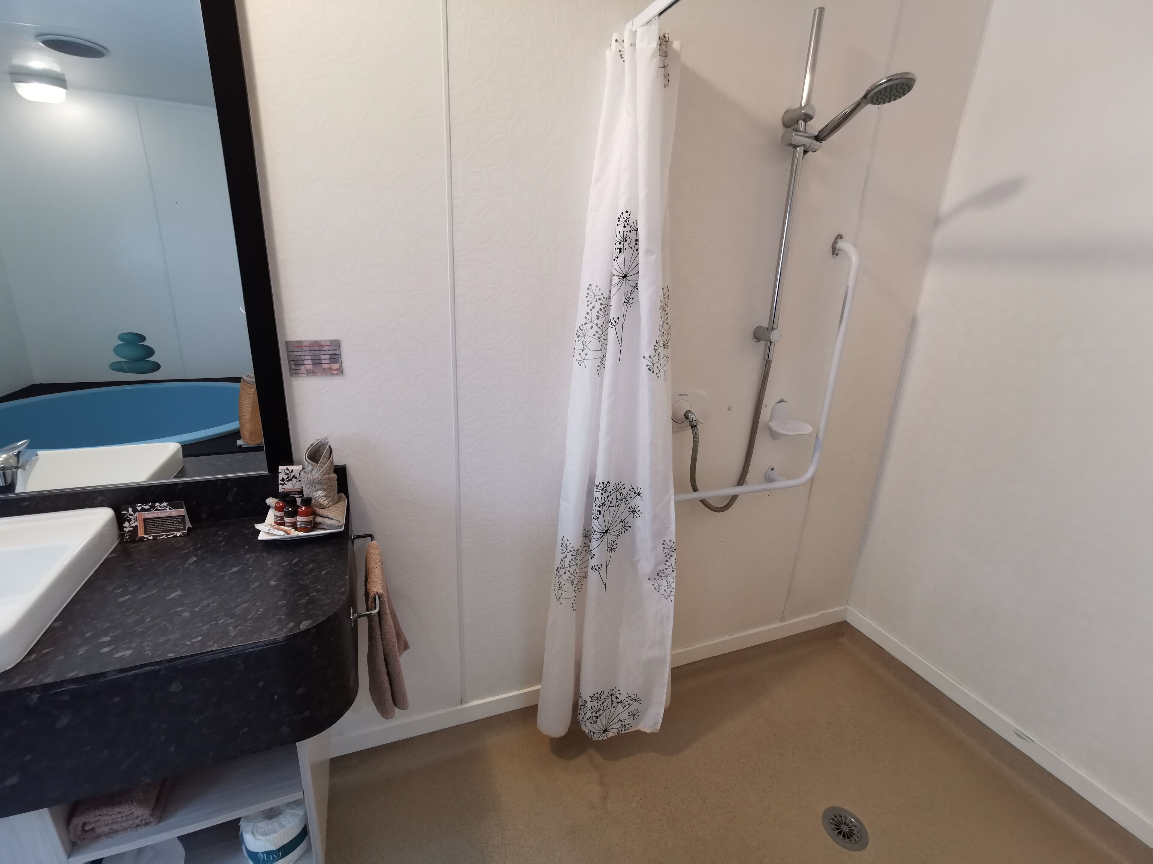Un baño con bañera, ducha, lavabo y espejo.