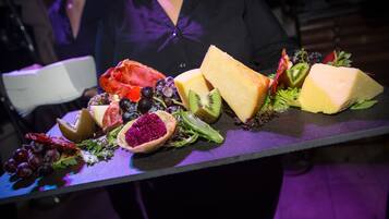 Un plateau garni de fromages et de fruits variés, posé sur une table.
