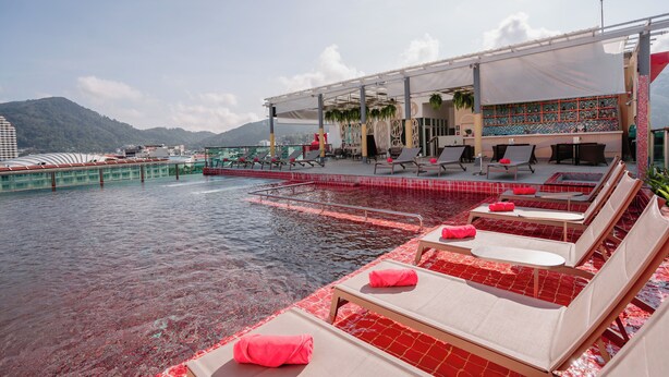 A rooftop pool area with lounge chairs and a covered seating area. - SLEEP WITH ME HOTEL design hotel @ patong (Patong)