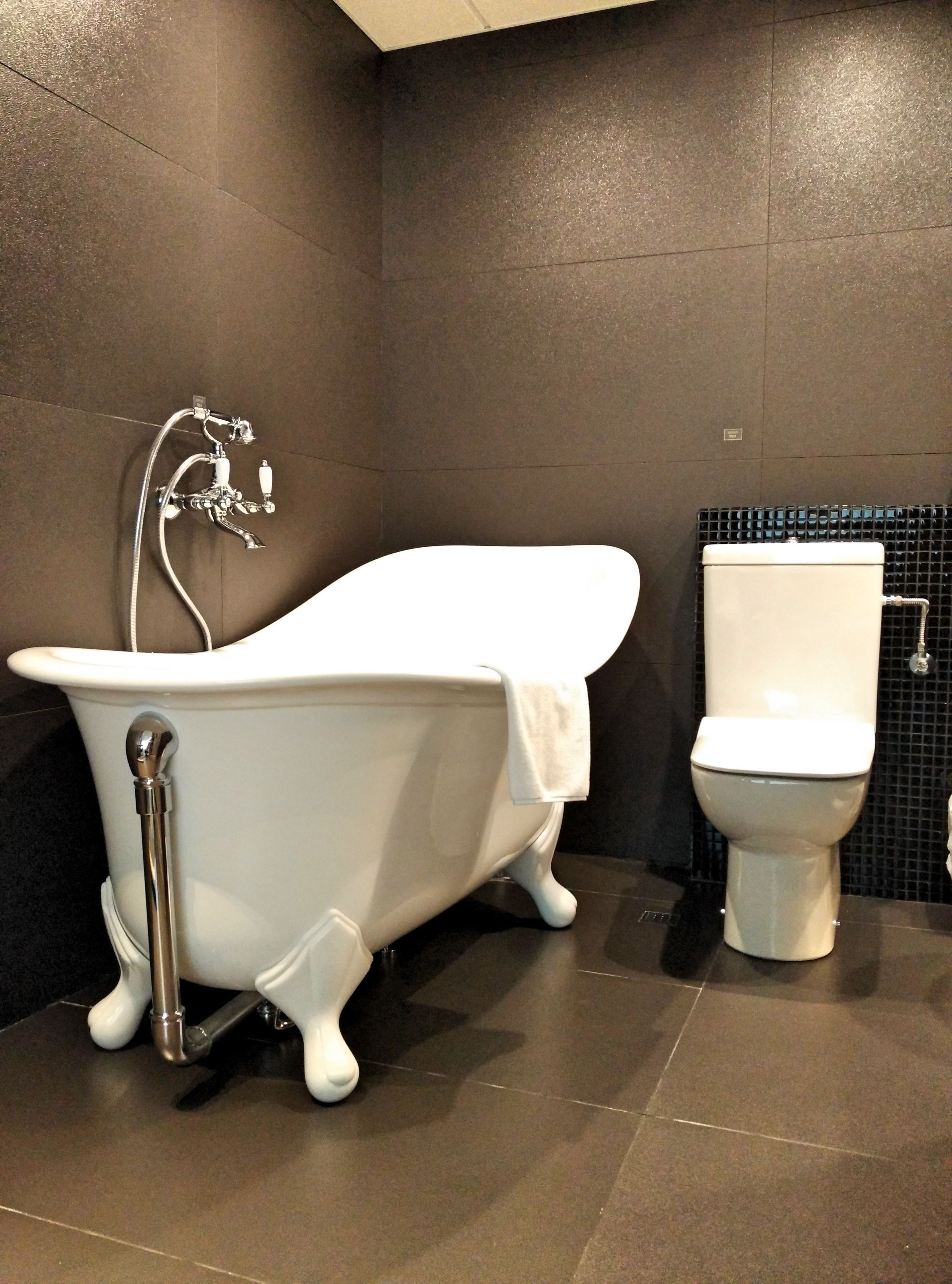 designer toiletries, hair dryer, slippers, towels