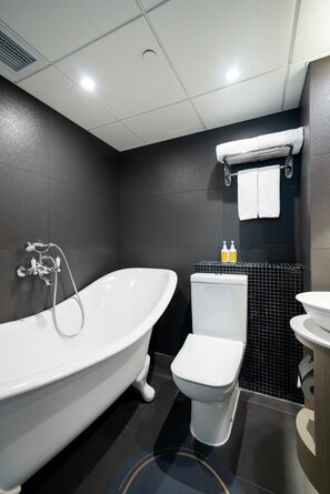 Signature Suite | Bathroom | Designer toiletries, hair dryer, slippers, towels