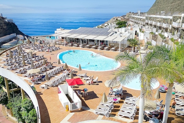 Outdoor pool, open 11:00 AM to 6:00 PM, pool umbrellas, pool loungers