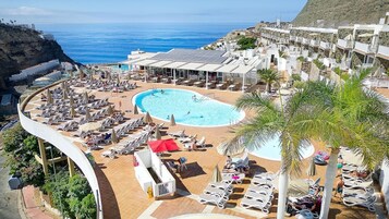 Outdoor pool, open 11:00 AM to 6:00 PM, pool umbrellas, pool loungers