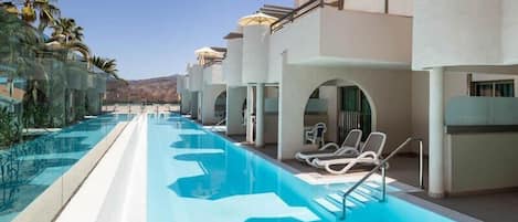 Outdoor pool, open 11:00 AM to 6:00 PM, pool umbrellas, pool loungers