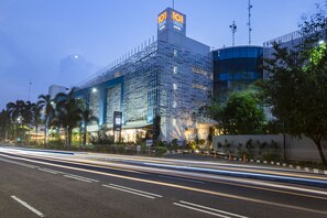A modern hotel with a prominent '101 Urban Hotel' sign, featuring a glass facade and a rooftop antenna. - 1O1 URBAN Jakarta Kelapa Gading (Jakarta)