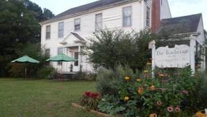 A white building with a sign reading "The Teachetage." - The Teacherage (Sunbury)