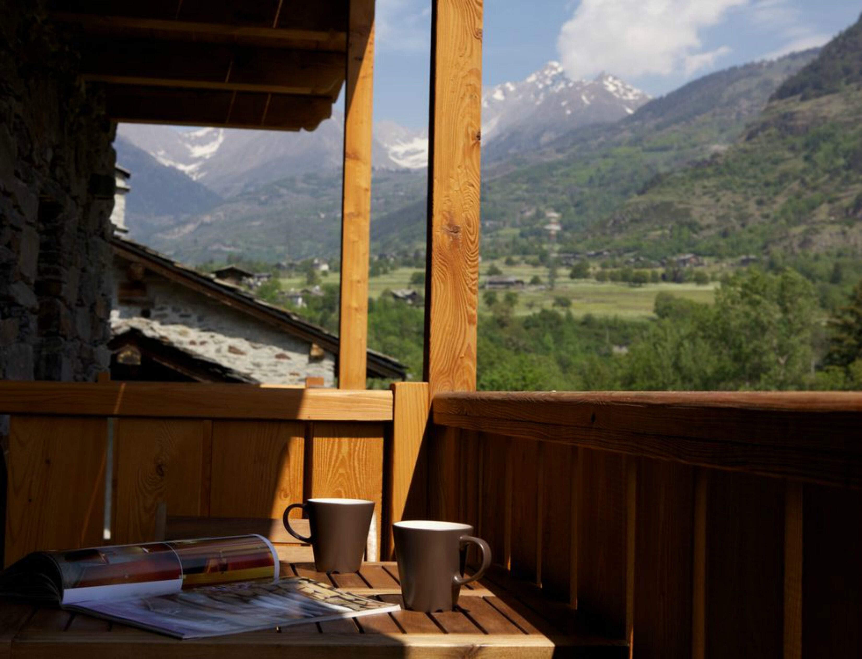 A wooden deck with a view of a mountainous landscape.