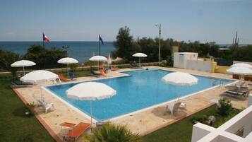 Seasonal outdoor pool, an infinity pool, pool umbrellas, sun loungers