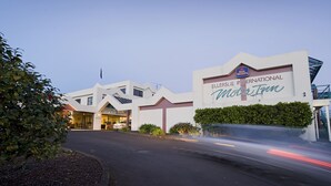 The exterior of the ELLERSLIE INTERNATIONAL MOTOR TOWN hotel with a clear entrance and signage.
