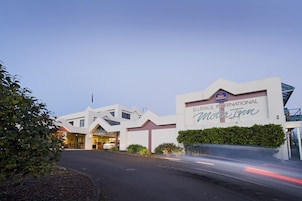 The exterior of the ELLERSLIE INTERNATIONAL MOTOR TOWN hotel with a clear entrance and signage.
