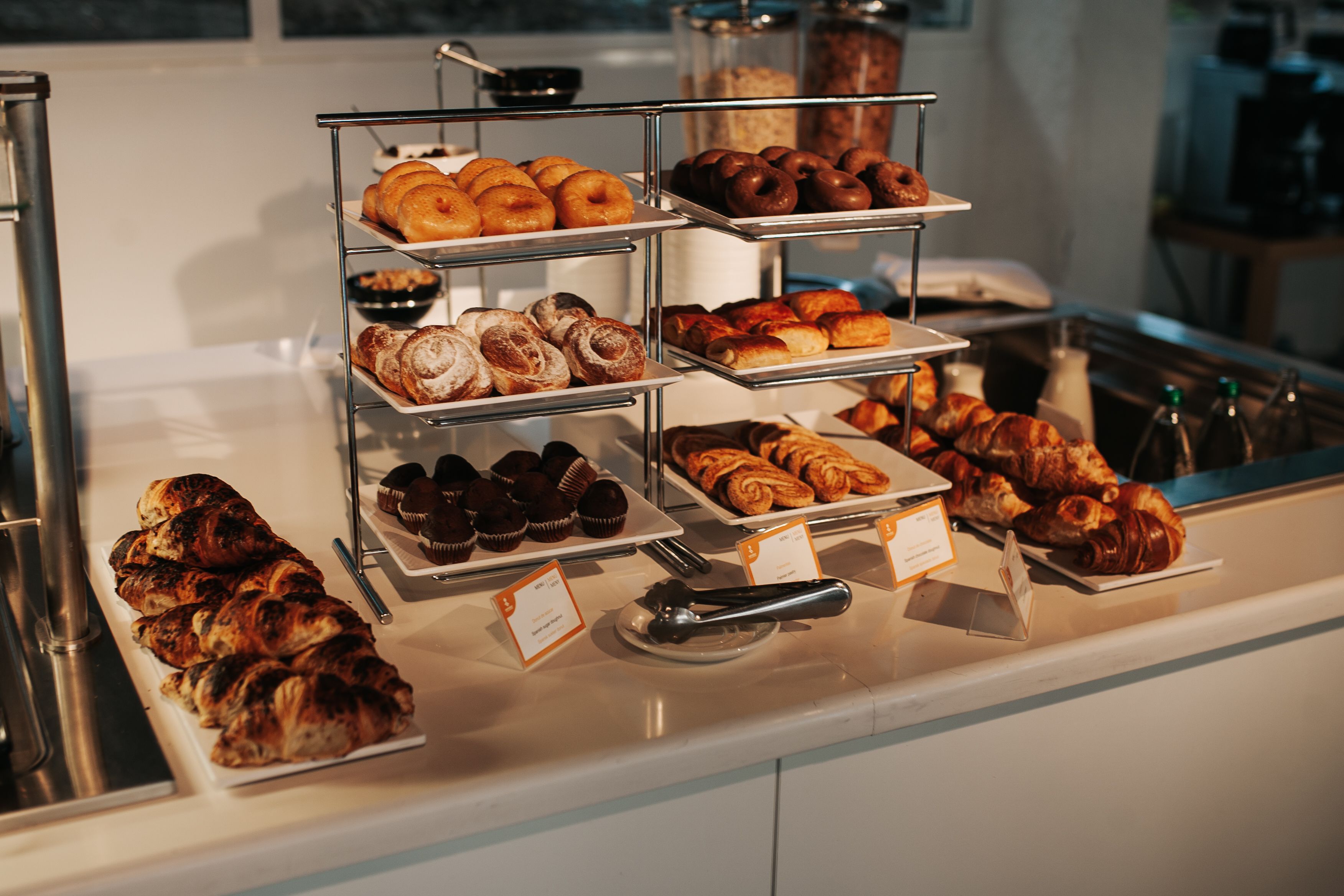 A bakery display with various pastries and baked goods.