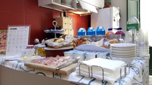 A buffet table with various food items and condiments, including meats, cheeses, and beverages. - Casalicchio B&B (Trapani)