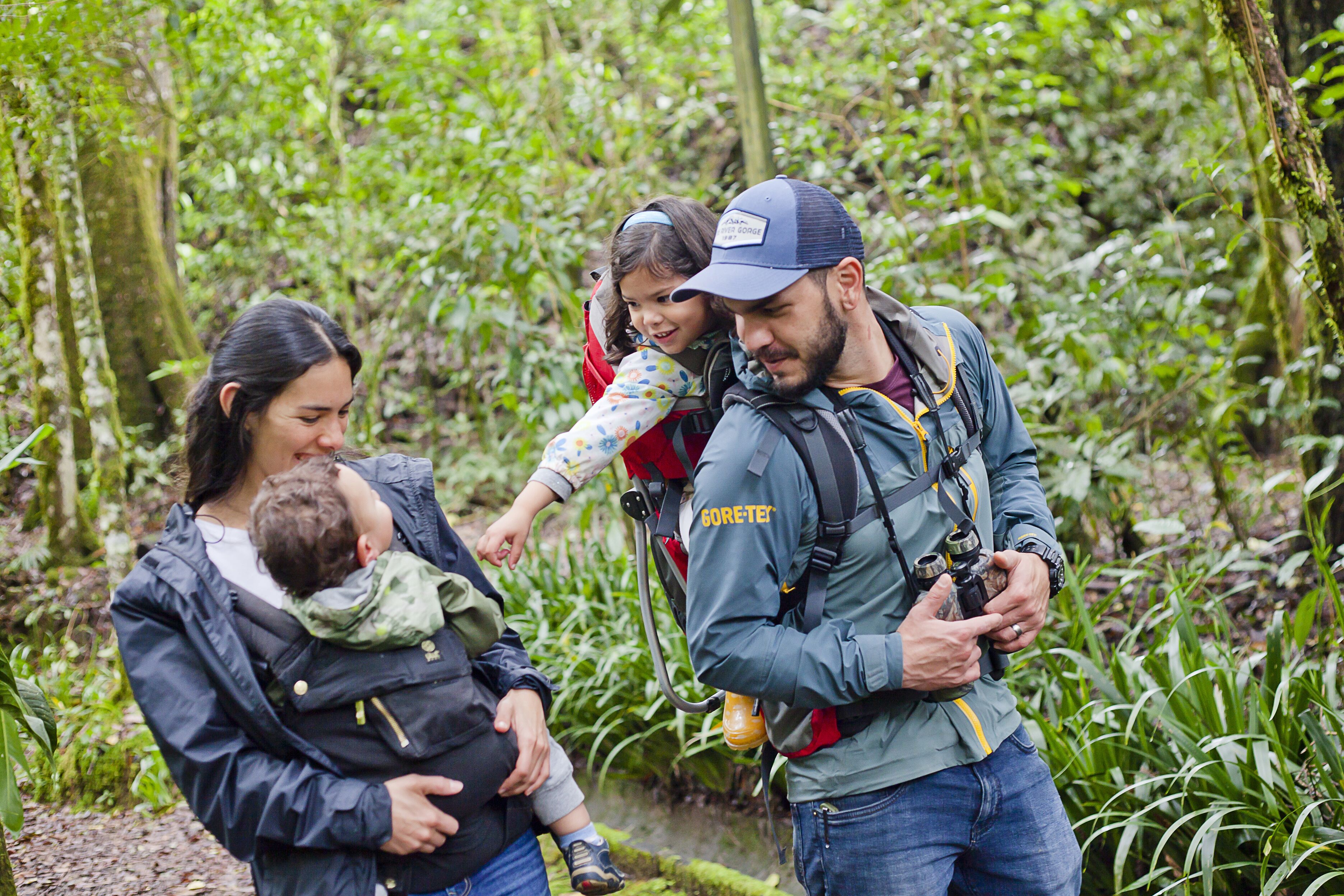 A family hiking in a lush forest.