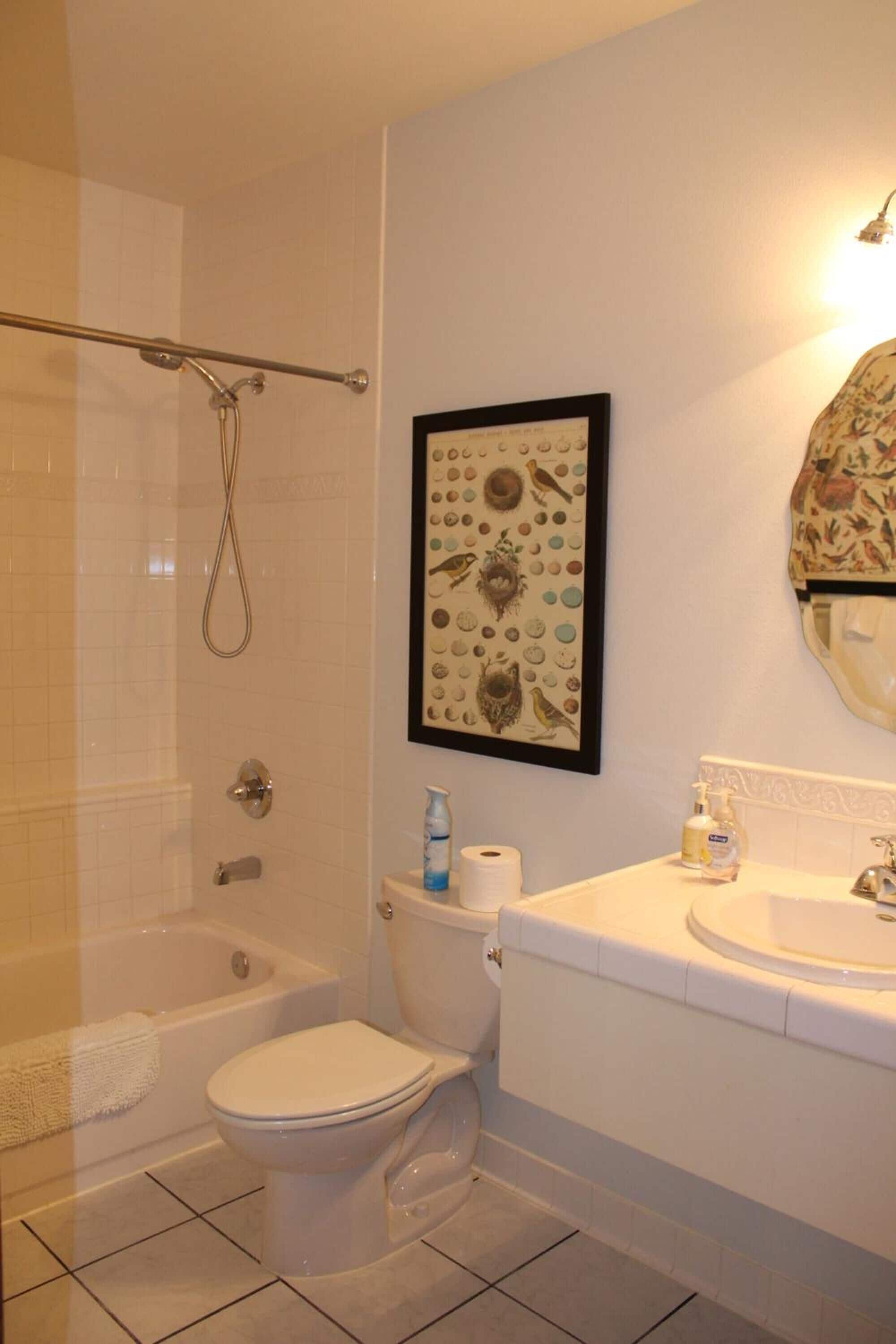 A bathroom with a bathtub, toilet, and sink.