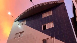 A hotel with a modern design, featuring a prominent triangular facade and multiple windows with shutters. - Saint Patrick Praia Hotel (Maceió)