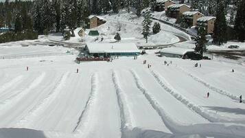 A snow-covered ski resort with multiple buildings and ski slopes.