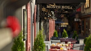 An outdoor cafe named Monte Rosa with tables and chairs arranged for dining. - Hotel Monte Rosa (Zermatt)