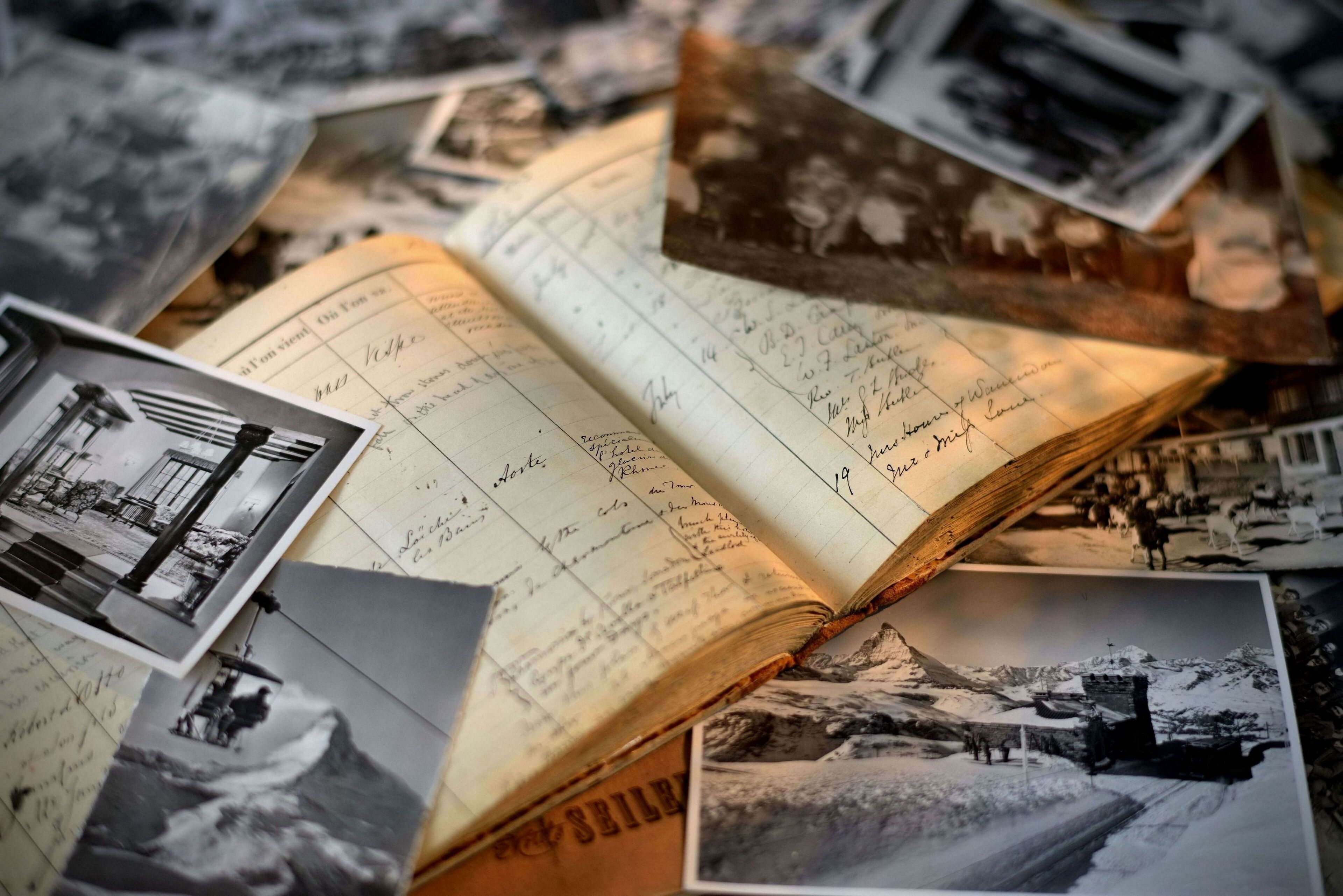 An open book with handwritten notes and photographs.