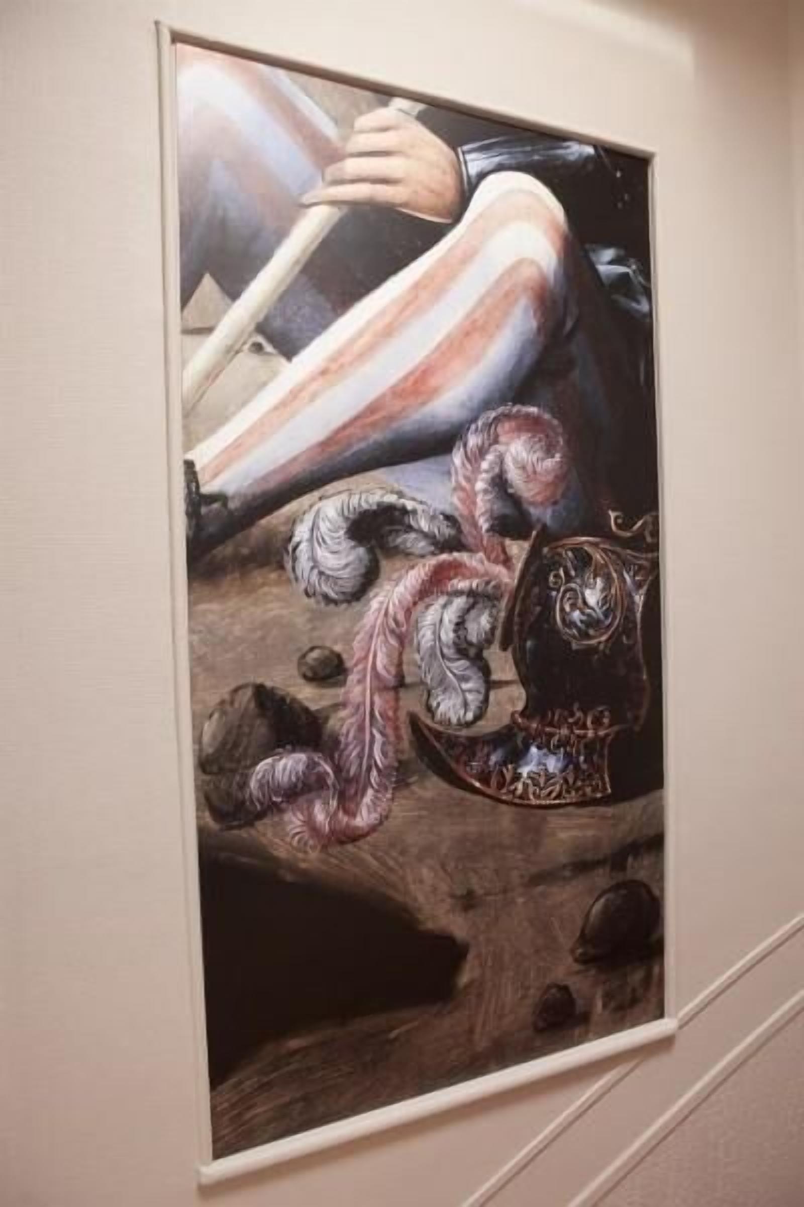 A framed artwork depicting a figure in a dynamic pose with a dragon-like creature, set against a textured background.