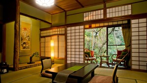 A traditional Japanese room with tatami flooring, a low table, and sliding doors.