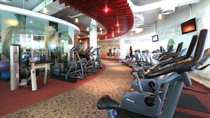 A gym with cardio machines, weight equipment, and a curved ceiling design. - Pattaya Sea View Hotel (Pattaya)