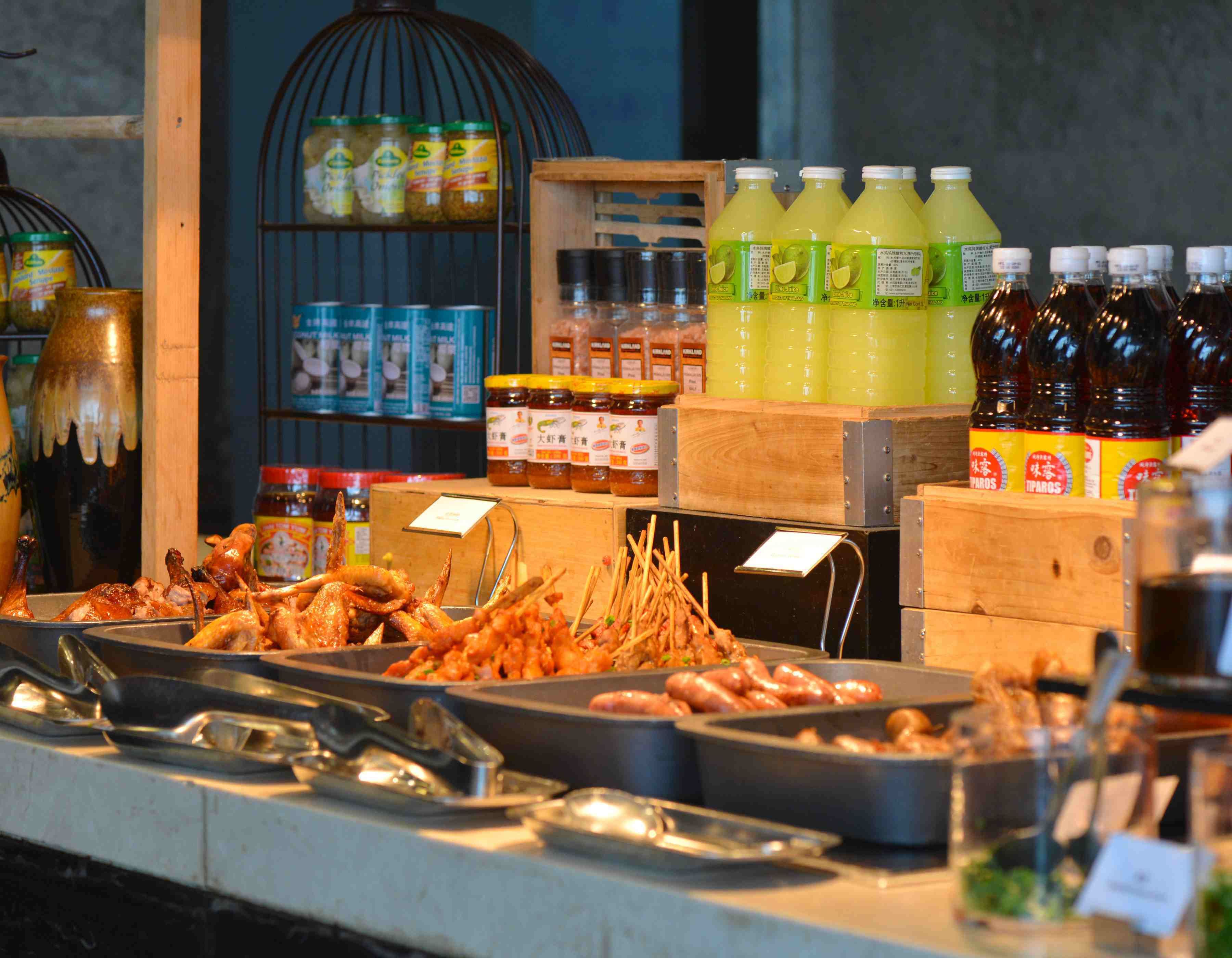 A buffet with various food items and condiments.