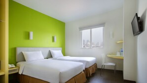 A hotel room with two beds, a desk, a chair, a TV, and a window with a city view. - Amaris Hotel Dr. Susilo Grogol (Jakarta)