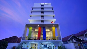 A modern hotel with a multi-story structure, a prominent logo at the top, and a brightly lit entrance. - Amaris Hotel Dr. Susilo Grogol (Jakarta)