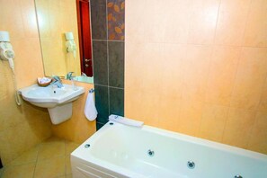A bathroom with a sink, a mirror, a telephone, and a bathtub. - Noris Hotel Plovdiv (Plovdiv)