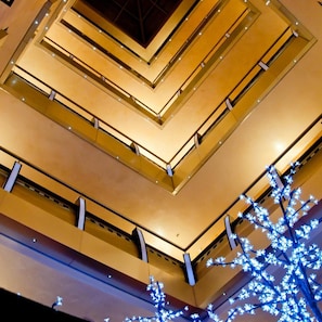 A multi-level atrium with a geometric ceiling design and illuminated structural elements. - Noris Hotel Plovdiv (Plovdiv)
