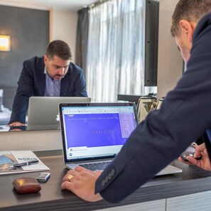 A business meeting with laptops on a table, a notepad, and a pen. - Noris Hotel Plovdiv (Plovdiv)