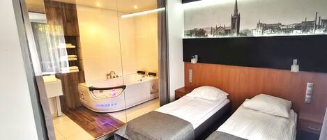 Chambre Deluxe avec lits jumeaux | Coffre-fort, bureau, systĂšme dâinsonorisation, fer et planche Ă repasser