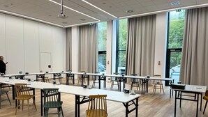 A conference room with long tables, chairs, and a projector. - Campanile Warszawa Polnoc (Warsaw)
