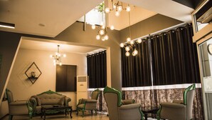 A room with a sofa, chairs, a coffee table, and a chandelier. - Nazar Hotel (Trabzon)