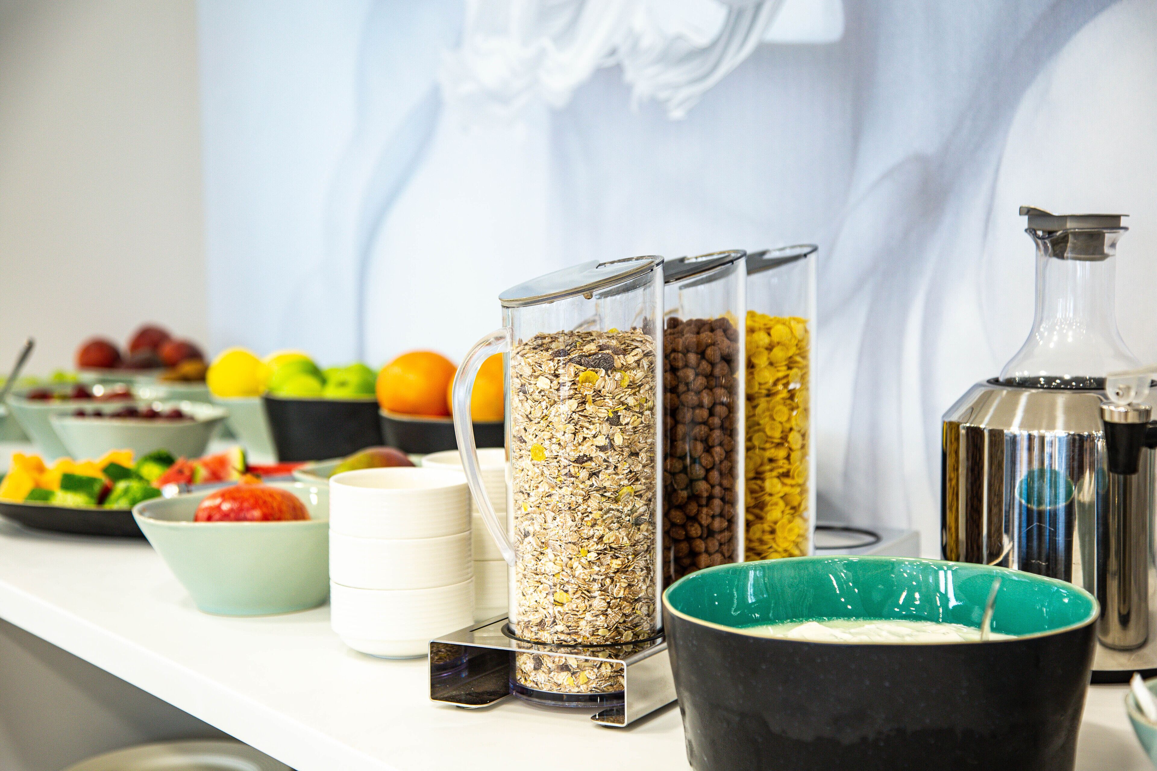 A buffet table with various food items and containers.