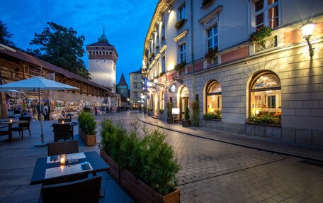 A historic square with cobblestone streets, outdoor seating, and traditional architecture.