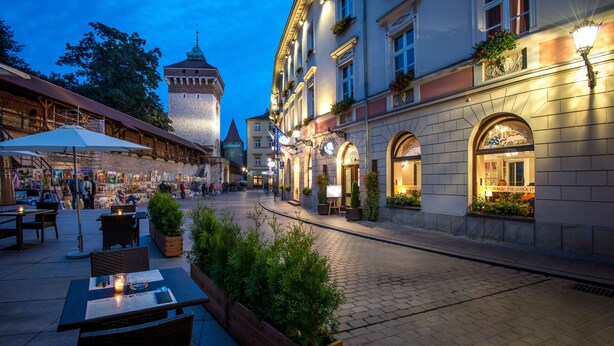A historic square with cobblestone streets, outdoor seating, and traditional architecture. - Hotel Polski Pod Białym Orłem (Kraków)