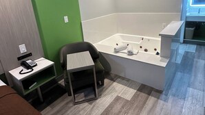 A modern bathroom with a bathtub, a small table, and a chair. - Garden Inn Hotel 花園酒店 - Pasadena, San Gabriel - Los Angeles (Temple City)