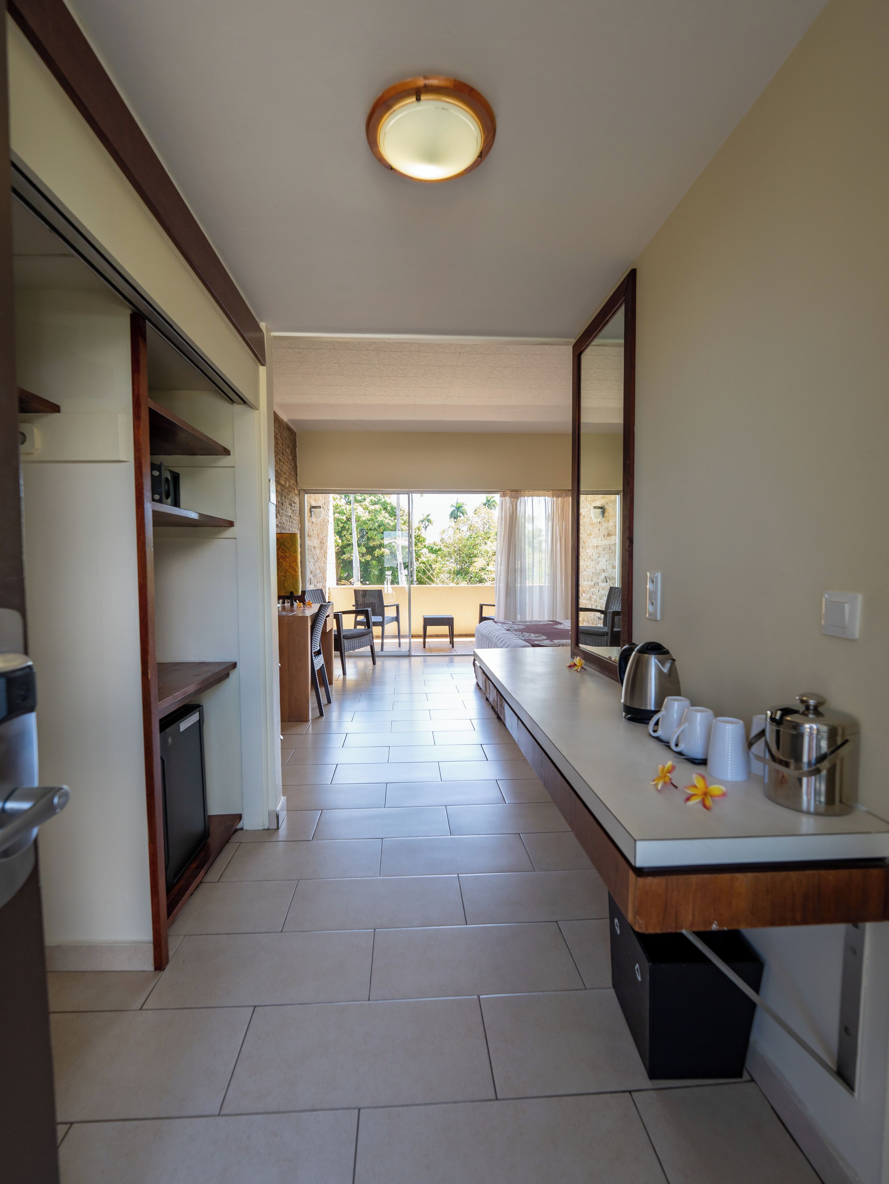 A modern kitchen with a dining area, a small table, and a view of the outdoors.